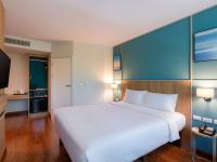 a large white bed in a hotel room at Ibis Phuket Patong in Patong Beach
