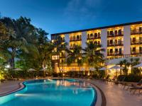 a hotel with a swimming pool in front of a building at Ibis Phuket Patong in Patong Beach