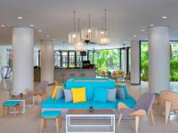 a living room with a blue couch and chairs at Ibis Phuket Patong in Patong Beach