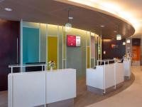 a lobby with a reception desk in a building at Ibis Phuket Patong in Patong Beach