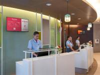 a group of men standing at a reception desk at Ibis Phuket Patong in Patong Beach