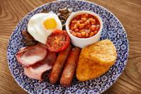 a plate of breakfast food with eggs sausage beans and toast at Arlington Hotel O'Connell Bridge in Dublin