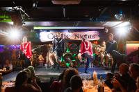 a group of performers on a stage in front of a crowd at Arlington Hotel O'Connell Bridge in Dublin
