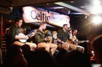a group of men sitting in a room playing music at Arlington Hotel O'Connell Bridge in Dublin