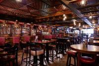 a restaurant with tables and chairs and a bar at Arlington Hotel O'Connell Bridge in Dublin