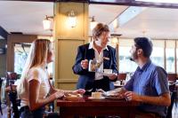 three people sitting at a table in a restaurant at Arlington Hotel O'Connell Bridge in Dublin