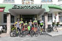a group of people standing in front of a store with their bikes at Sporthotel Igls in Innsbruck