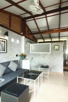 a living room with a couch and a table at Oon Lee Bungalows in Ko Jum