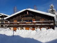 a log cabin with snow on the roof at APPARTEMENT PLEIN SUD AUX SAISIES N°6 in Les Saisies
