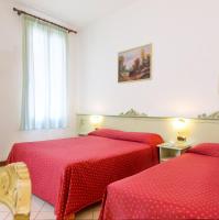 a bedroom with two beds with red sheets and a window at Guesthouse Ca&#39; San Marcuola 1 in Venice
