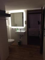 a bathroom with a toilet and a sink and a mirror at Pension Karina Schwerin in Schwerin