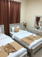 Postel nebo postele na pokoji v ubytování Al Khaleej Plaza Furnished Apartments LLC