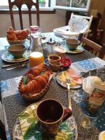 a table with a breakfast of eggs and food on it at Au Nid de la Madeleine in Gaillac