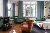 a bedroom with a bed and a tv and a chair at ABode Manchester in Manchester