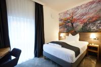 a bedroom with a bed and a large window at Hotel Garni am Schloss in Kottenheim