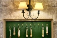 a display of surgical tools hanging on a wall at Au Saint Roch - Hôtel et Jardin in Avignon