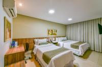 Plaza Inn Breeze Aeroportoにあるベッド