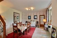 a dining room with a table and a kitchen at Chambres d&#39;hôtes Air Marin in Lannion