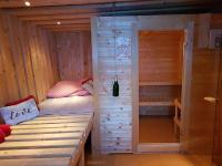 a bedroom with a bed in a wooden cabin at Der Perweinhof in Donnersbachwald