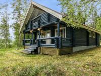 a log cabin with blue pipes on the front of it at Holiday Home Tiira by Interhome in Himahuuha