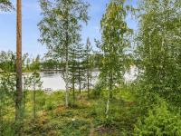 a view of a river through a forest with trees at Holiday Home Tiira by Interhome in Himahuuha