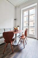 a dining room with a table and two chairs and a couch at Modern Apt 3BDR&#47;3BATH - Louvre Museum&#47;Tuileries in Paris