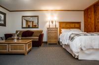 a hotel room with a bed and a chair at Kandahar Lodge at Whitefish Mountain Resort in Whitefish