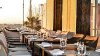 a row of tables and chairs at a restaurant at Holiday Inn Algiers - Cheraga Tower by IHG in Alger