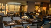 a restaurant with tables and chairs in a room at Holiday Inn Algiers - Cheraga Tower by IHG in Alger