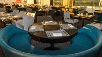 a dining room with tables and chairs with blue chairs at Holiday Inn Algiers - Cheraga Tower by IHG in Alger
