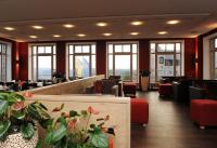 a restaurant with tables and chairs and windows at Hotel Schloss Waldeck in Waldeck