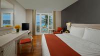 a hotel room with a large bed and a television at Amari Phuket in Patong Beach