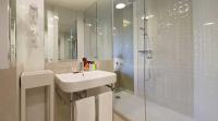 a white bathroom with a sink and a shower at Axel Hotel Barcelona - Adults Only in Barcelona