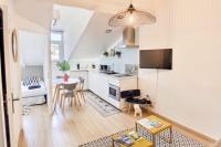 a living room with a kitchen and a table at Charming 1 bedroom apartment center in Cannes