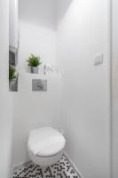 a bathroom with a toilet and a black and white floor at Charming 1 bedroom apartment center in Cannes