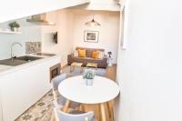 a kitchen and living room with a table and a couch at Charming 1 bedroom apartment center in Cannes