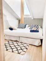 a bedroom with two beds with pillows and a rug at Charming 1 bedroom apartment center in Cannes