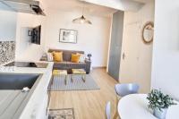 a living room with a couch and a table at Charming 1 bedroom apartment center in Cannes