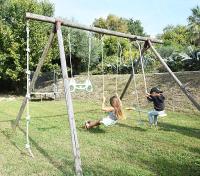 two children playing on a swing set in a yard at Villa Angel in La Gaude