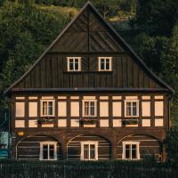 a house with a gambrel roof with flower boxes at Pension Rokytka in Kryštofovo Údolí