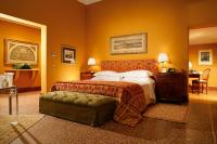 a hotel room with a bed and a chair at Villa Spalletti Trivelli - Small Luxury Hotels of the World in Rome