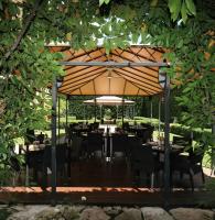 a restaurant with tables and chairs under a large umbrella at Villa Spalletti Trivelli - Small Luxury Hotels of the World in Rome