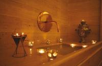 a bathtub with candles and a mirror and lights at Villa Spalletti Trivelli - Small Luxury Hotels of the World in Rome