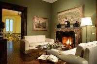 a living room with two couches and a fireplace at Villa Spalletti Trivelli - Small Luxury Hotels of the World in Rome