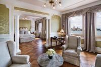 a living room with a bed and a table and chairs at Baglioni Hotel Luna - The Leading Hotels of the World in Venice