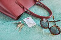 a pair of keys and a bag with a pair of glasses at Hotel Metropol by Maier Privathotels in Munich