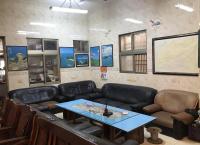 a waiting room with a table and leather furniture at Fu Yuan B&amp;B in Magong