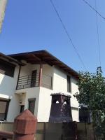 a building with a large bell in front of it at Camere Centrale in Piteşti