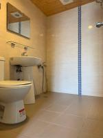 a bathroom with a toilet and a sink and a shower at EasyInn Hotel &amp; Hostel in Tainan