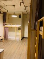 a room with two bunk beds and a hallway at EasyInn Hotel &amp; Hostel in Tainan